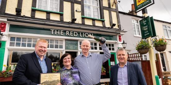 Members of Greene King and Siobhan and Chris outside The Red Lion 